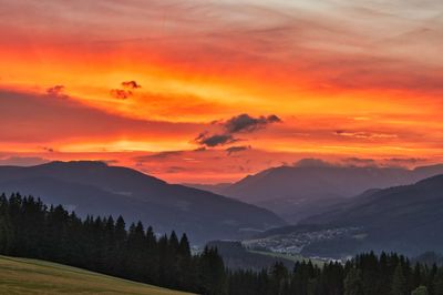 Scenic view of mountains against orange sky