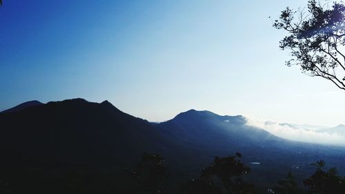 Scenic view of mountains against clear blue sky