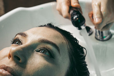 Close-up of man washing hands