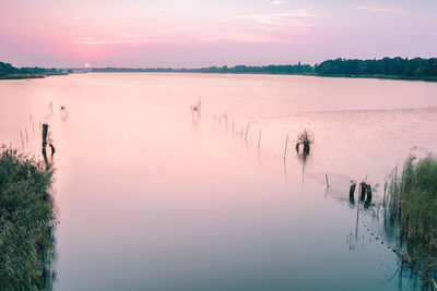 Scenic view of calm lake at sunset