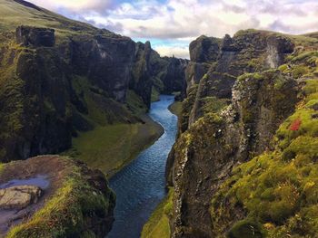 Scenic view of river amidst mountains against sky