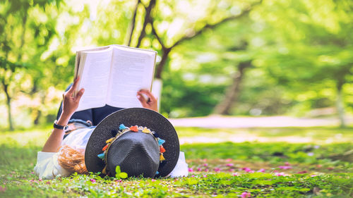 Woman reading book in park