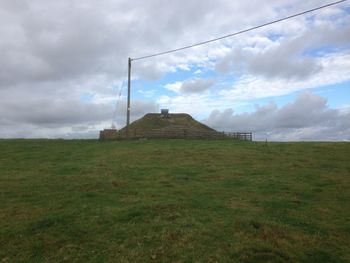 Built structure on field against sky