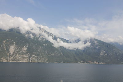 Scenic view of sea and mountains against sky