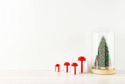 Christmas decorations on table against white background