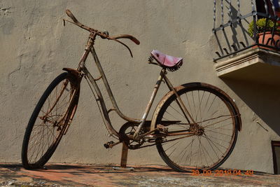 Bicycle parked against wall