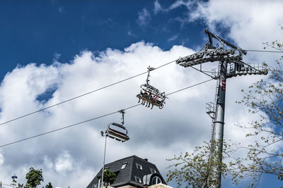 Low angle view of telephone pole against sky