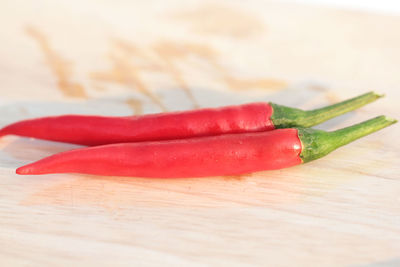 Close-up of red chili peppers on table