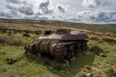 Abandoned car on field