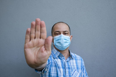 Portrait of man covering face with hands