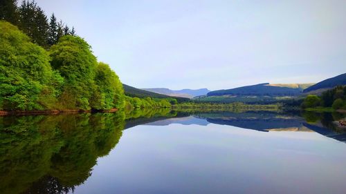 Scenic view of lake and mountains against clear sky