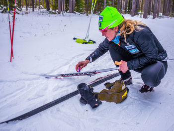 Rear view of girl skiing on snow