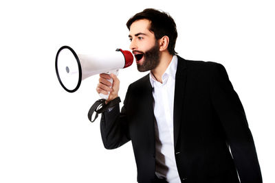 Man with arms raised standing against white background