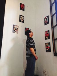 Young man standing against wall