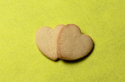 Close-up of heart shape cookies on yellow background