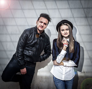 Portrait of young couple standing outdoors