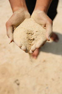 Close-up of hand holding sand