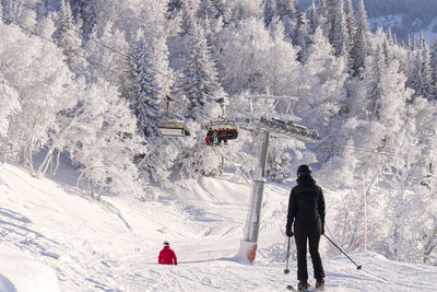 Rear view of man skiing on snow