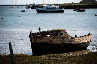 Abandoned boat moored in sea