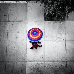 High angle view of woman standing on multi colored tiled floor