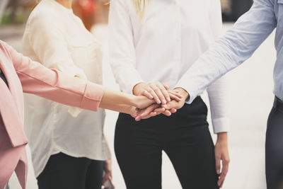 Midsection of couple holding hands