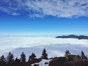 Scenic view of mountains against cloudy sky