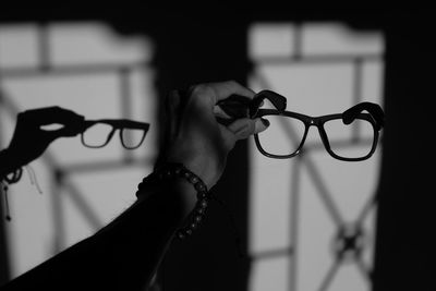 Close-up of woman hand holding eyeglasses