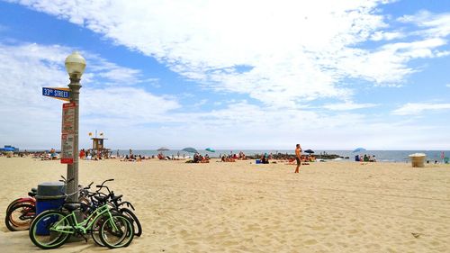 People on beach against sky