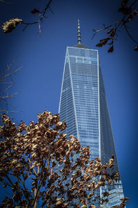 Low angle view of skyscrapers against clear blue sky