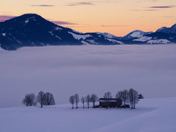 Scenic view of snowcapped mountains during sunset