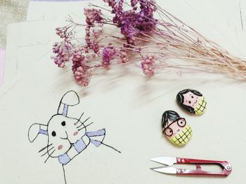 High angle view of painting and flowers on table