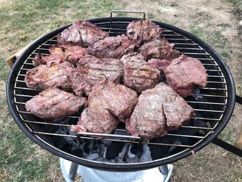 High angle view of meat on barbecue grill