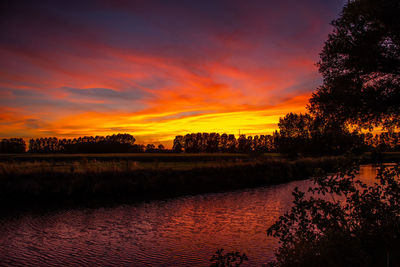 Scenic view of lake against romantic sky at sunset