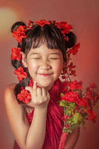 Close-up portrait of a girl with red flower
