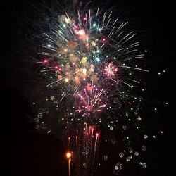 Low angle view of firework display at night