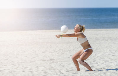 Full length of young woman on beach