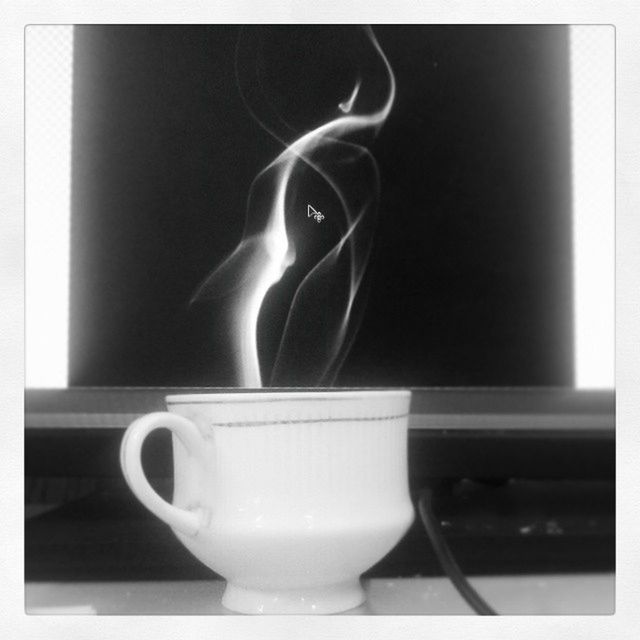 CLOSE-UP OF COFFEE CUP ON TABLE WITH SPOON