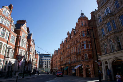 City street amidst buildings against sky