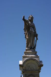 Low angle view of statue against clear blue sky