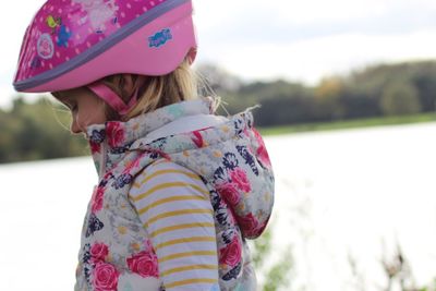 Side view of girl wearing pink cycling helmet