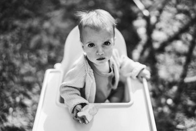 Portrait of young woman sitting on field