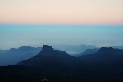 Scenic view of mountains against cloudy sky