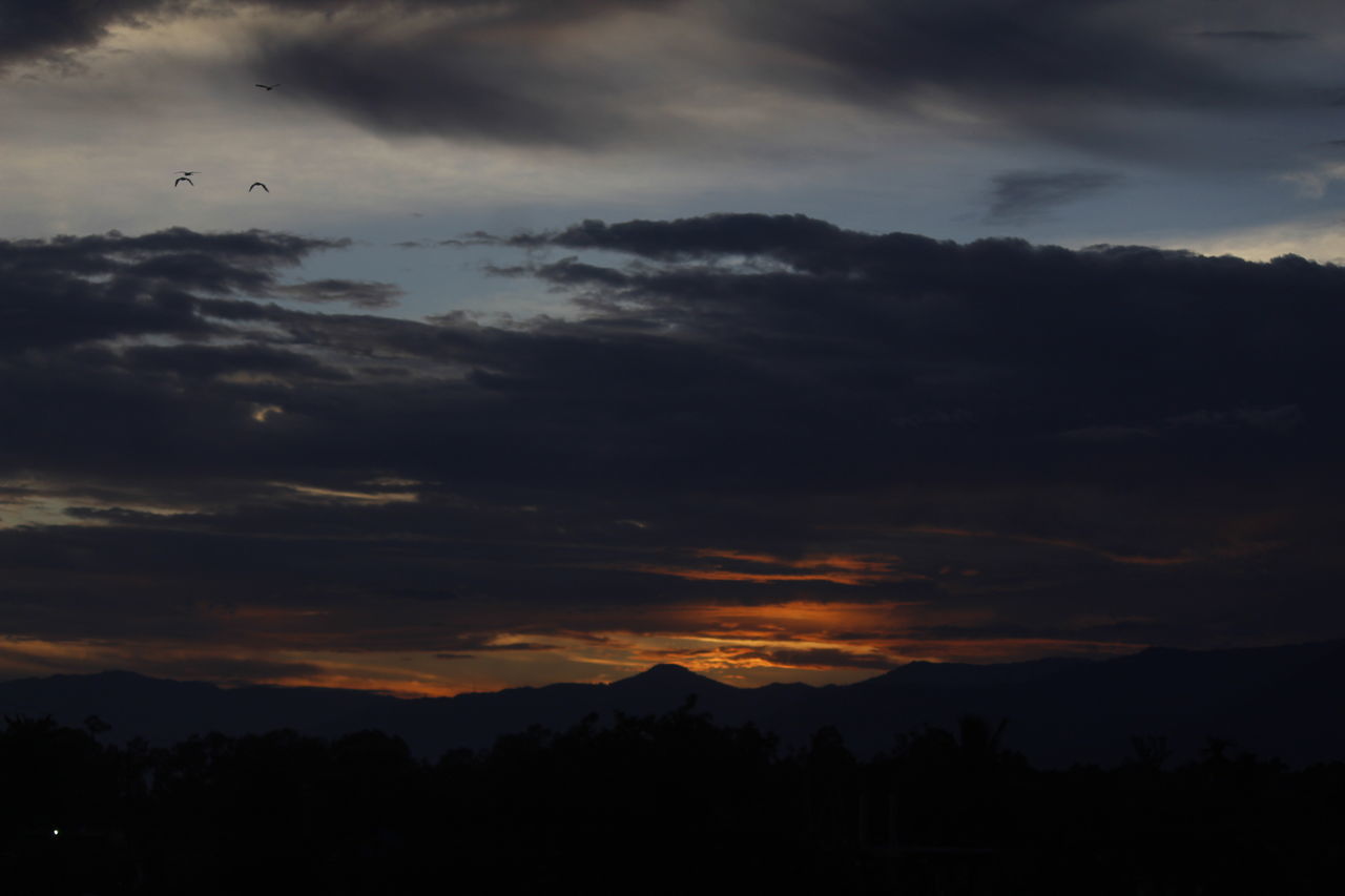 sky, cloud, beauty in nature, scenics - nature, mountain, silhouette, tranquility, darkness, nature, tranquil scene, morning, dawn, environment, no people, landscape, tree, sunrise, mountain range, dramatic sky, outdoors, idyllic, horizon, plant, land, non-urban scene, afterglow, sunlight