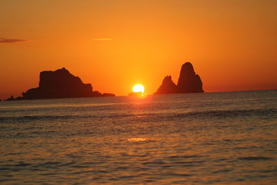 Scenic view of sea against orange sky