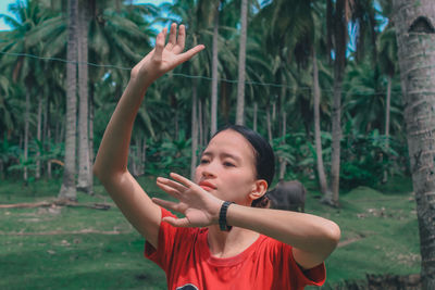 Side view of boy playing with arms raised