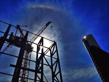 Low angle view of crane against sky