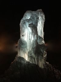 Low angle view of rock formations at night