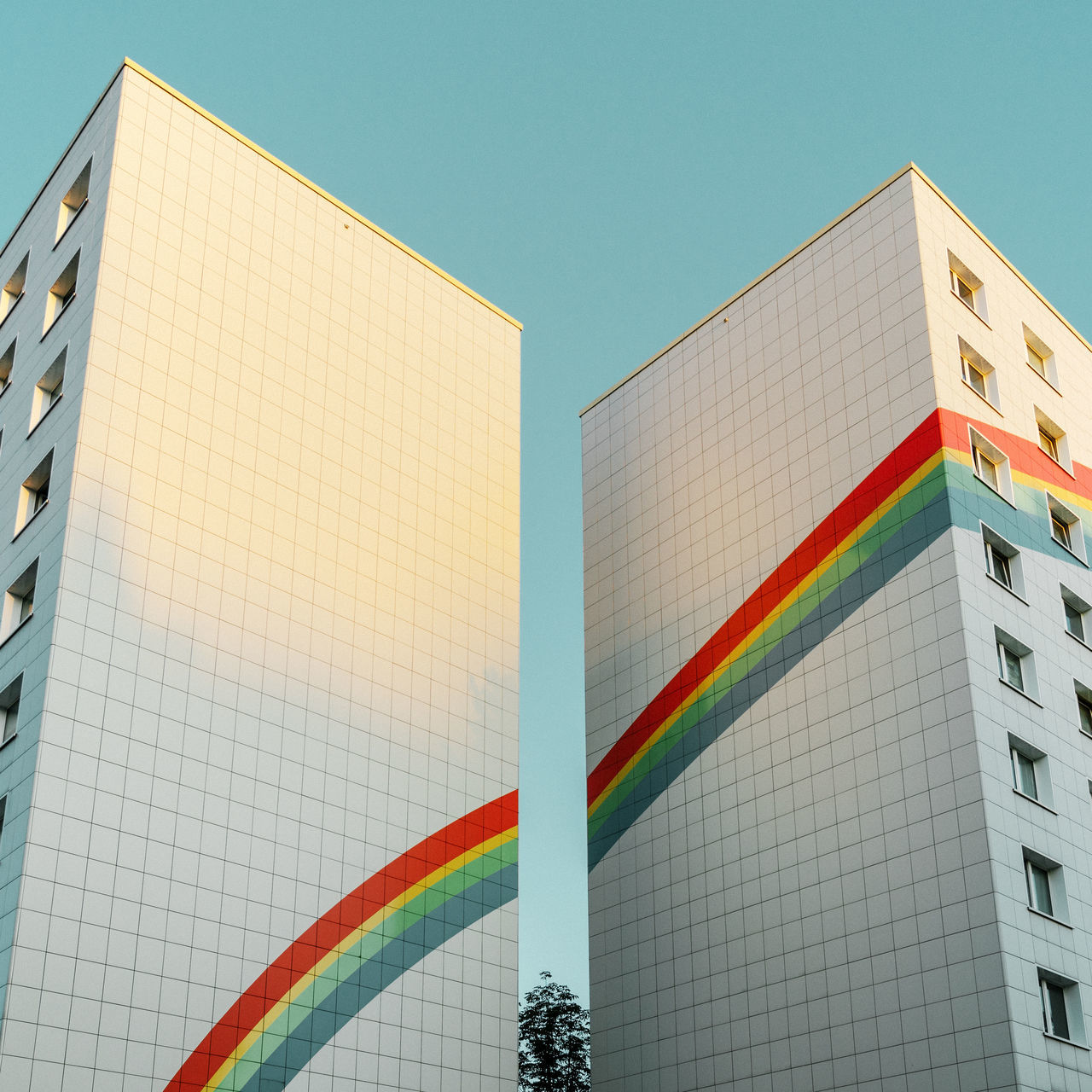 architecture, built structure, building exterior, multi colored, low angle view, building, sky, no people, clear sky, nature, day, city, modern, office building exterior, tall - high, outdoors, pattern, office, wall - building feature, art and craft