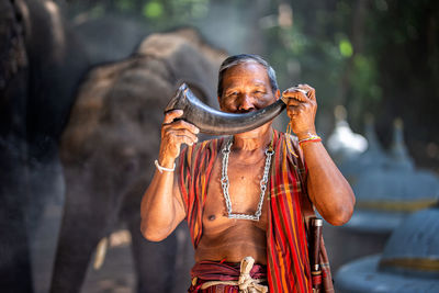 Man holding horn in forest