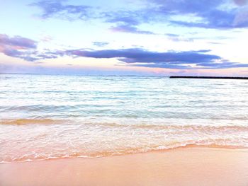 View of calm sea against cloudy sky